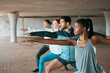 © Haas/peopleimages.com - Team, exercise and friends stretching as a fitness club for sports, health and wellness in an urban class together. Sport, commitment and people training or group doing pilates workout in yoga