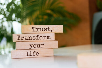 Wall Mural - Wooden blocks with words 'Trust, transform your life'.