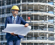 senior businessman architect helmet construction site building architecture tablet computer protective workwear blueprint plan