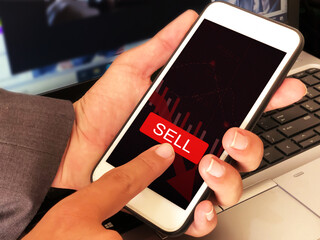 Poster - Man selling share on mobile by touching the screen and red button. Sell button with red graph going down concept backdrop