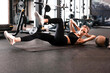 © ty - Young woman in sportswear doing crunches at the gym, top view.