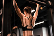 © ty - Women doing pull ups training arms in the gym. Upper body training.