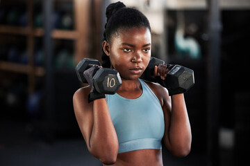 Canvas Print - Fitness, dumbbells or strong black woman training, exercise or workout for powerful arms or muscles. Wellness, health or African girl lifting weights or exercising shoulders with energy in gym studio