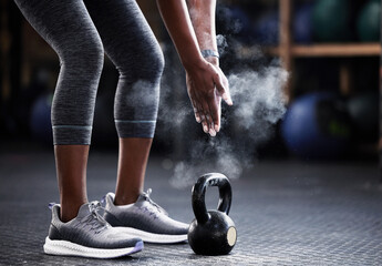 Fitness, kettlebell or hands of woman with powder to start training, workout or exercise for grip strength. Body builder, floor or healthy athlete with chalk dust at gym ready for lifting weights