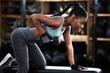© Michael Cunningham/peopleimages.com - Gym, dumbbell or strong black woman on bench training, exercise or workout for powerful arms or muscles. Wellness, health club or African girl lifting weights or exercising shoulders with fitness