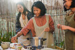© Sabrina - Happy asian mother and adult daughters cooking together thai traditional food at home patio