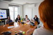 © Media Lens King - Business woman talking to her business partners at a meeting, multi ethnic group
