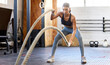 © Anela Ramba/peopleimages.com - Fitness, battle ropes or strong woman training for grip strength in workout or body exercise in gym club. Wellness, mindset or healthy female sports athlete with biceps power, resilience or focus