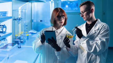 Poster - students in laboratory. guy and girl chemists. man and woman work as laboratory assistants. students