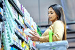© Anela Ramba/peopleimages.com - Grocery, shopping and choice with woman in supermarket for food, retail or label reading. Product, nutrition and health with female customer and basket in store for diet, discount and price inflation