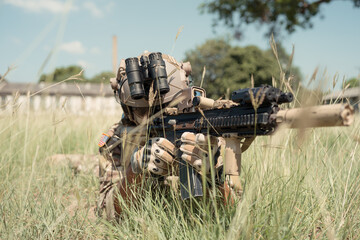 Special forces soldier in camouflage with a pair of weapons that are full of modern technology and complete for battle