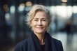 Mature smart swedish businesswoman, smiling face, standing in blur background of modern office building. Generative AI AIG20.