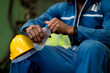 © KANGWANS - Tired engineer working hard in industrial factory. sit back and drink water