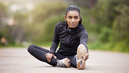 Canvas Print - Nature, warm up and woman stretching legs while sitting, workout motivation and fitness mindset with hands on feet. Focus, commitment and girl on floor, leg stretch for outdoor run and exercise goals