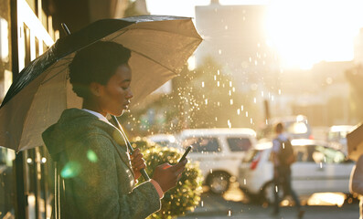 umbrella, phone and black woman in a city, rain and connection with mobile app, network and chatting