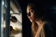 © Niko_Dali - Balanced nutrition and healthy breakfast before training. Night eating, a girl stands near an open refrigerator at night, generative AI.