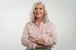 © gzorgz - Attractive elderly woman with gray hair standing with arms crossed at isolated white background