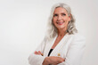 © gzorgz - Attractive elderly woman with gray hair standing with arms crossed at isolated white background