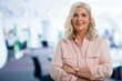 © gzorgz - Attractive elderly business woman with gray hair standing with arms crossed at the office