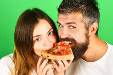 Couple Sharing Pizza And Eating Together. Young Hipster Male And Female Couple Home Eating Pizza Snack. Beautiful Loving Couple In Casual Clothes Enjoy Pizza. Husband And Wife Eating Pizza. Closeup.