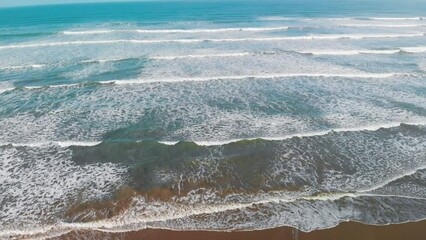 Wall Mural - Beautiful waves along the shoreline, overhead aerial view from drone