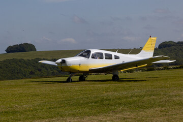 Wall Mural - Popular single engined private monoplane on the grass airfield.