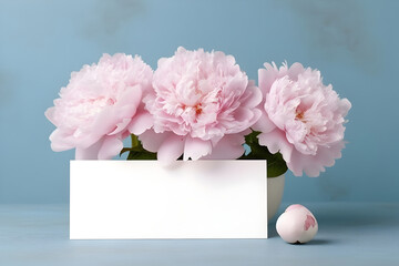 Wall Mural - Blank greeting card mockup with garden peonies in a vase on pastel blue background. Summer template composition with flowers and copy space. AI generated.