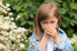 © New Africa - Little girl suffering from seasonal pollen allergy near blossoming tree on spring day