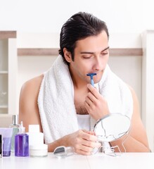 Wall Mural - Young handsome man in the bathroom