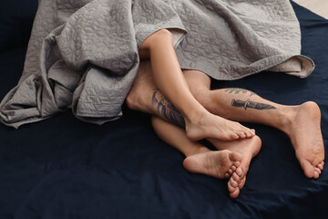 Wall Mural - passionate couple having sex on bed, closeup of legs