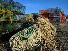 Tons Of Various Colored Ropes And Lobster Pots Or Traps Sit On A Rockport Massachussets Dock At Dusk