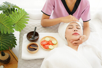 Wall Mural - Woman spa body and face treatment and massage aroma therapy product relax and healthy and beauty. Spa Thai therapy treatment aromatherapy for body and face. Young woman enjoying and relax massage 