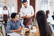 © Kawee - Caucasian waiter receiving order serving from customer in restaurant.