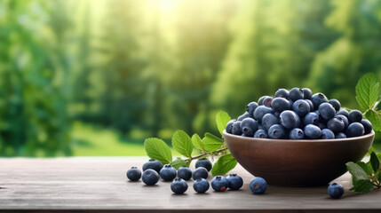 Blueberries in a bowl on a wooden table, blurred green background.