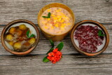 Assorted of Indonesian traditional porridge, such as  bubur jagung Mutiara (corn sago), bubur mutiara (sago) bubur biji salak (sweet potatoe). Indonesian food. 