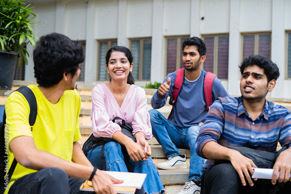 Group of happy students having chat with talking each other while ...