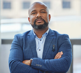 Confidence, crossed arms and portrait of a businessman in his office with a serious face expression. Career, professional and confident African male executive ceo posing in the modern workplace.