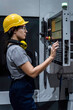 © Westend61 - Maintenance engineer operating CNC machine keypad in factory