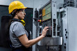 © Westend61 - Maintenance engineer wearing hardhat operating machine keypad in modern factory