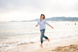 © Westend61 - Carefree woman running near shore at beach