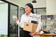 © bongkarn - Excited Asian female office worker shows her fist, feels happy to quit her job
