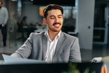 Poster - Young arab businessman working at the table in modern office