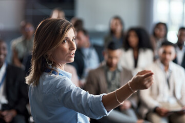 presentation, training and coaching with a business woman talking to an audience during a workshop. 