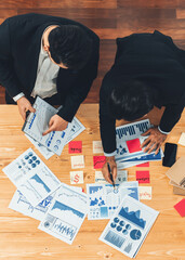 Poster - Top view analyst team discussing financial data on digital dashboard, analyzing chart and graph papers by data science software on wooden table background. Business intelligence and Fintech. Fervent