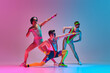 © master1305 - Funny image of three men in stylish, vintage sportswear training aerobics and gymnastics against gradient blue pink studio background. Concept of sportive and active lifestyle, humor, retro style. Ad