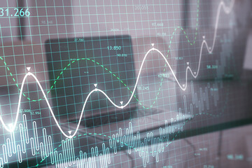 Poster - Close up of laptop at workplace with glowing candlestick forex chart on blurry backdrop. Trade, finance and technology concept. Double exposure.