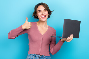 Poster - Portrait of charming excited person hold netbook demonstrate thumb up feedback isolated on blue color background