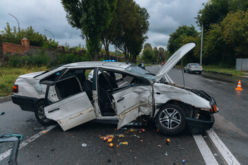 A car accident involving two cars on a city street. Damaged cars. Severe accident. Close-up.