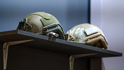 At the army clothing store, the helmet that comes with the soldier's khaki military attire is available for viewing.