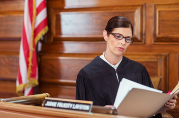 Wall Mural - Judge looking through documents and judges bench 